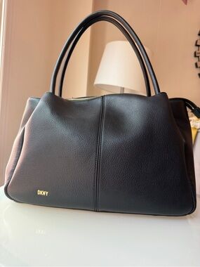 DKNY pebbled leather triple-compartment tote.